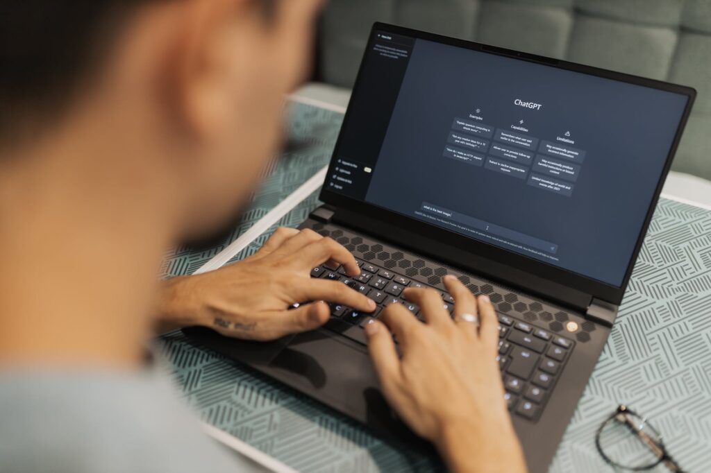 a person typing on a laptop computer