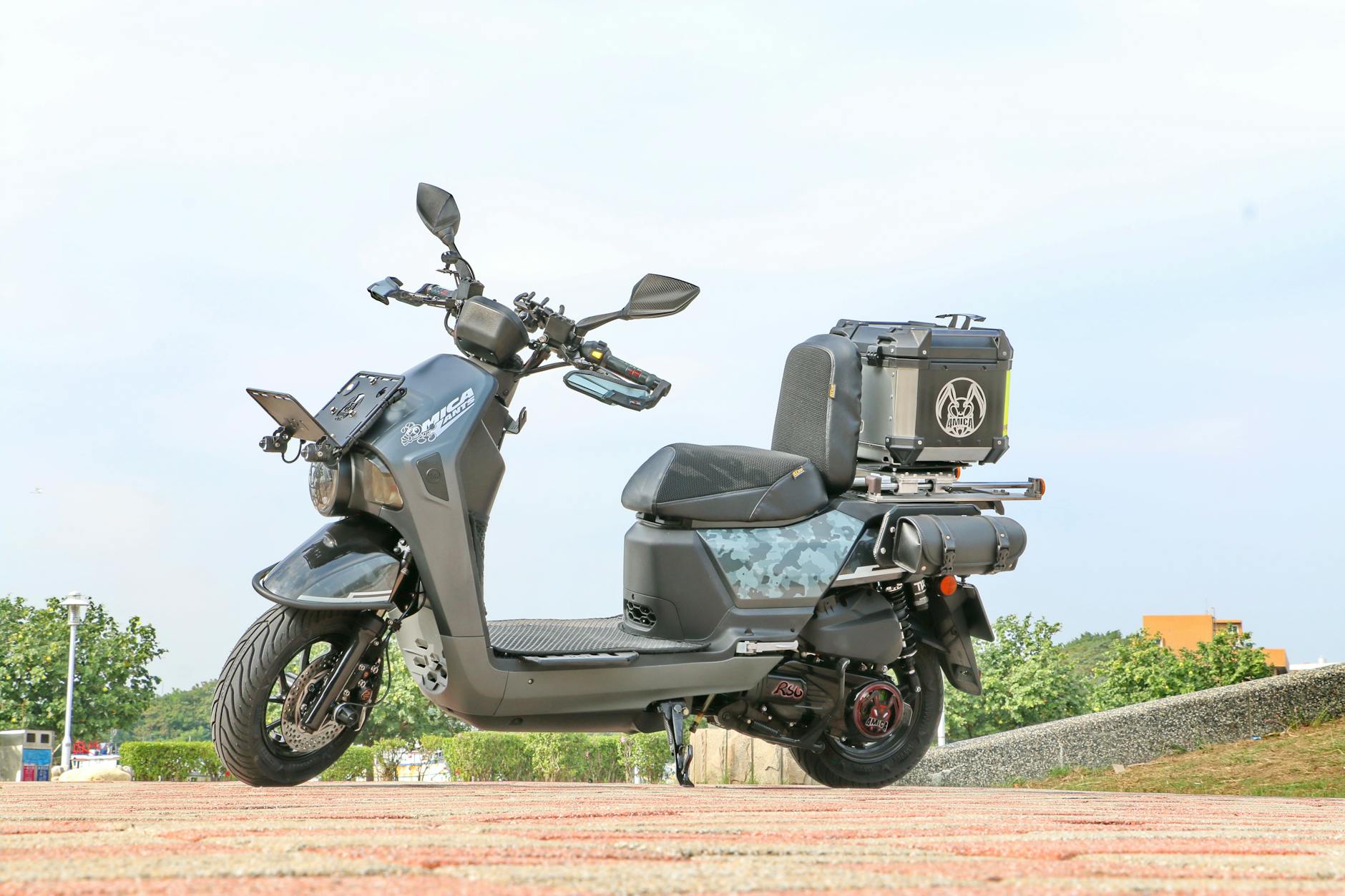 a black motor scooter parked on the road