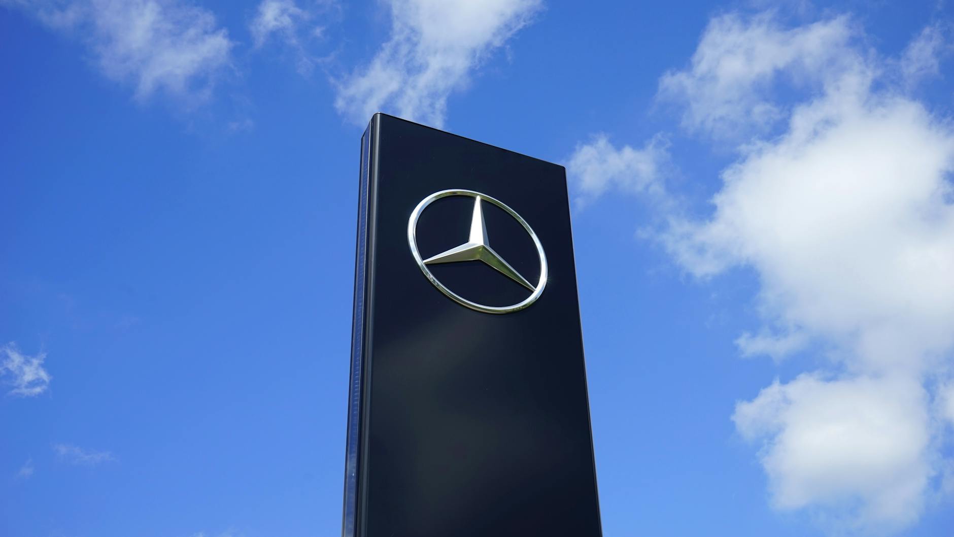 black mercedes benz building under blue and white sky